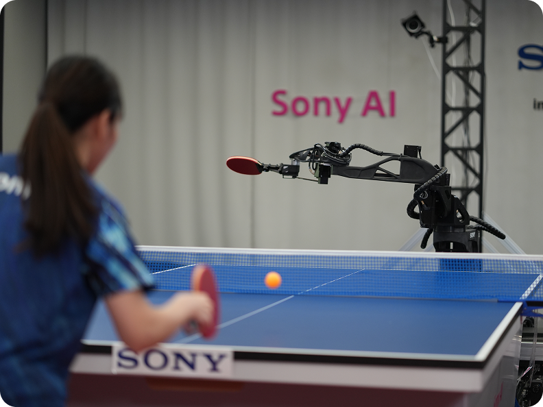 A female athlete plays table tennis with a robot.